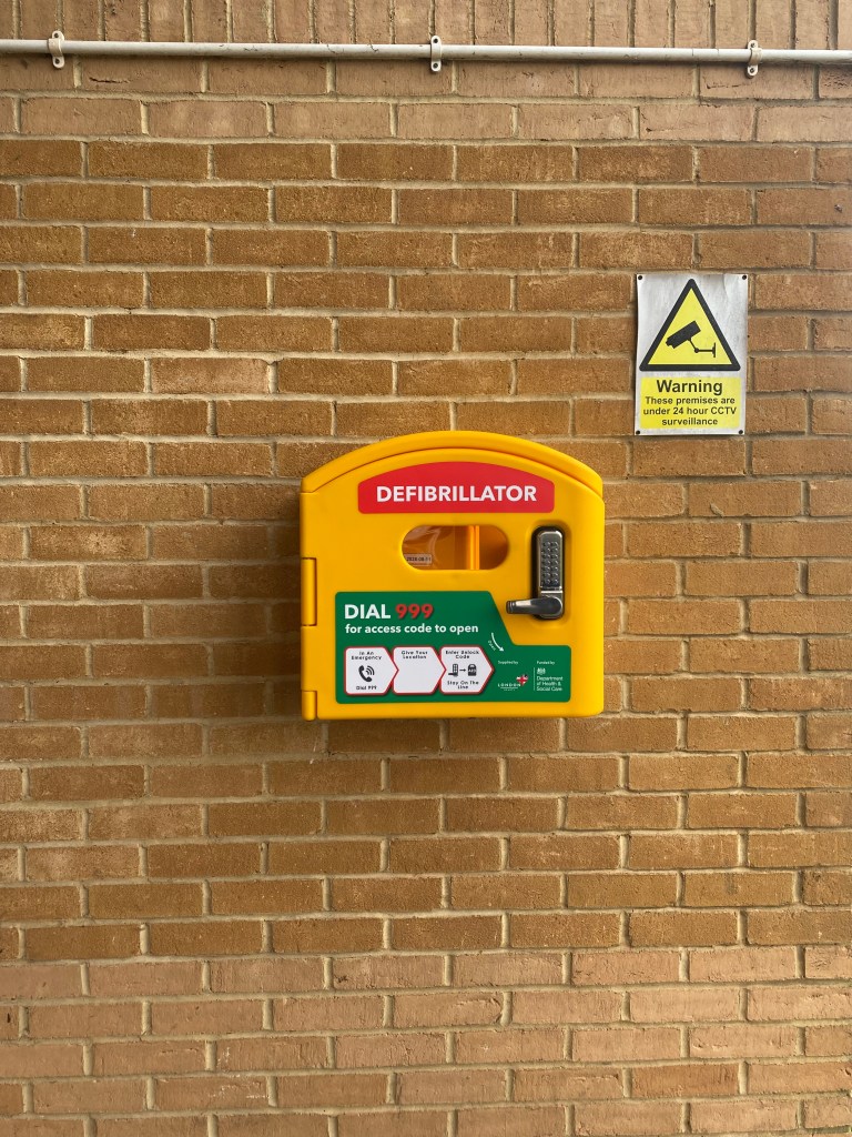Photograph of the new defibrilator on the Greenacre Hall